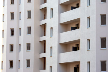 Modern residential building with balconies and large windows in a urban setting