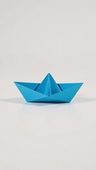 A neatly folded blue paper boat on a clean white background ideal for kids craft visuals and origami displays