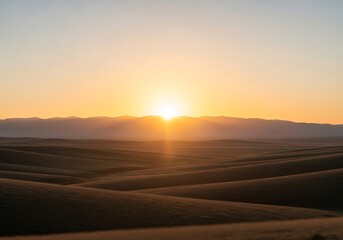 Scenic Landscape of Rolling Hills at Sunrise with a Mountain Backdrop Radiating Light