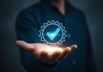 Photo of closeup of a mans hand holding a glowing digital badge with a checkmark, symbolizing quality assurance and approval