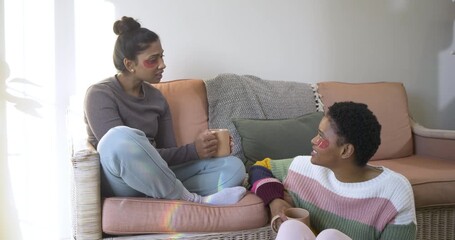 Conversation sparking Diverse female friends sipping coffee showing gel patches as chatting at home - Powered by Adobe