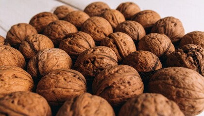 Close-up of whole walnuts with rough, ridged shells in earthy brown tones&mdash;highlighting natural texture, organic form, and rustic simplicity.