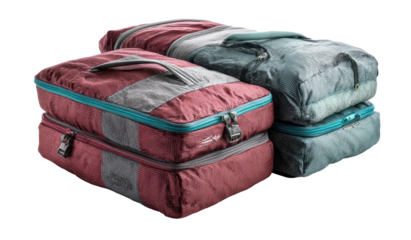 Two stacked, zippered travel packing cubes, in muted burgundy and gray, with teal accents