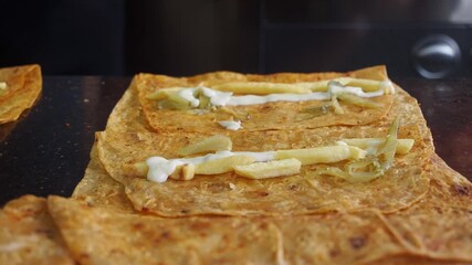 preparing sharma roll by adding chips and chicken slice on 