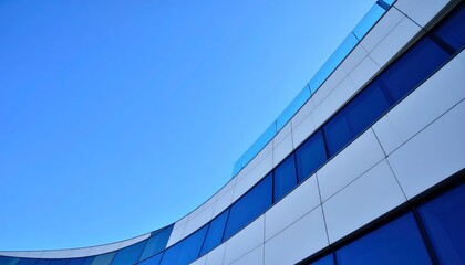Contemporary architecture, modern building design against blue sky, Curving facade of a modern office building with blue glass windows