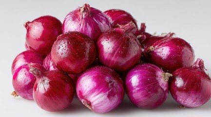 A pile of fresh, red onions with water droplets