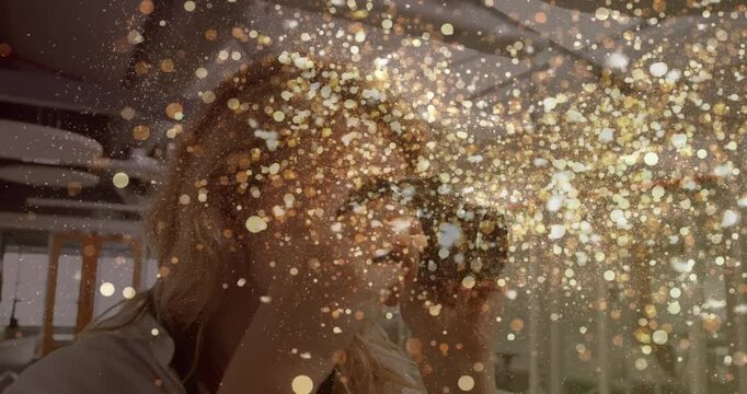 Photographer pressing shutter on mirrorless camera showcasing golden sparkles filling tech office