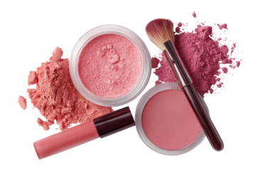 Pink blush, powder, and gloss cosmetics.  Top-down view of  makeup products.  A blush brush and containers with spilled powder