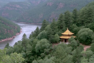 Fototapeta premium Serene Asian Temple Perched on Hillside Overlooking River and Mountains.