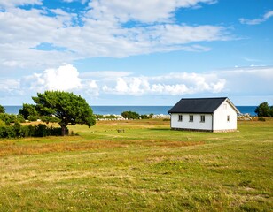 Obraz premium Coastal cottage, sunny meadow