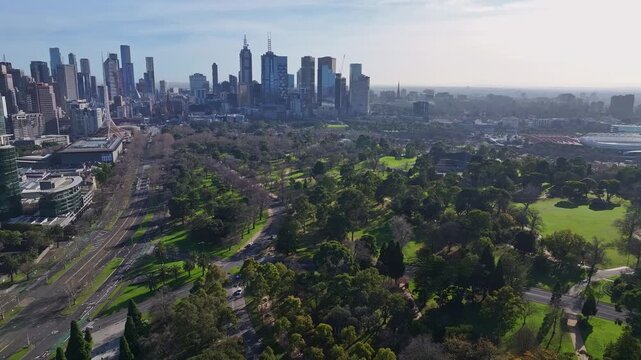 Melbourne skyline rising beyond parklands and urban green space