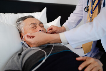 doctor put on oxygen mask for bedridden patient, elderly hopeless senior man lying on bed. home caregiver nurse visit retirement patient for health check up recovery process medical service