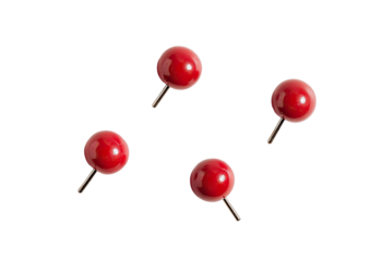 Four small, round, glossy, red pushpins against a black background