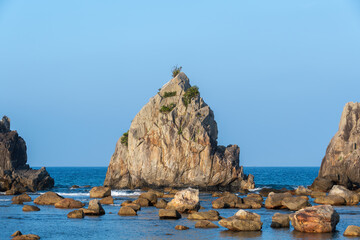 青空にそびえる橋杭岩の大岩