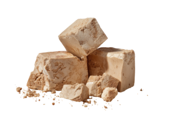 Stacked, light brown cubes of baked good, scattered crumbs
