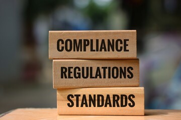 Stacked Blocks Displaying Compliance Regulations and Standards in Business Environment. isolated on...