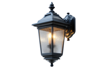 Exterior wall-mounted lantern with a warm-yellow light.  Dark gray metal casing with frosted glass. Ornate design