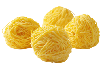 Four nests of yellow pasta, close-up