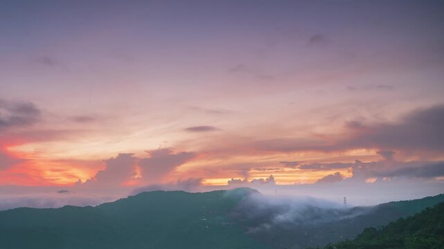 A spectacular summer sunrise over the mountains in Xindian, Taiwan, with a breathtaking sea of clouds and a vibrant, colorful sky.