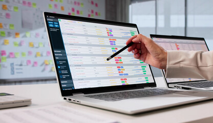 Financial Analyst Calculates Medical Data Using Spreadsheet On Laptop