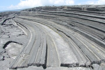 Layered, curved basalt rock formations