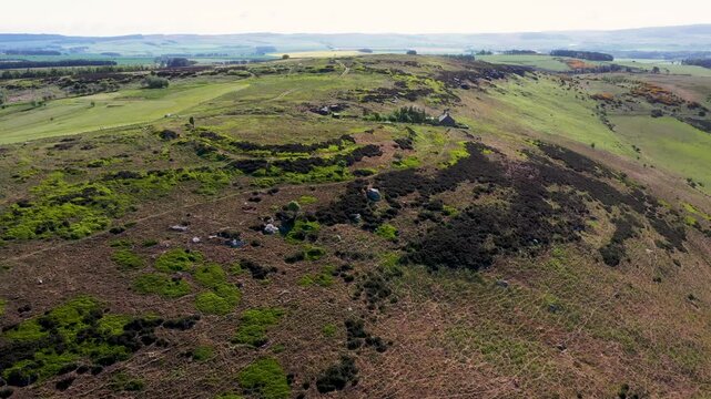 Dod Law West prehistoric Iron Age hillfort near Doddington, Northumberland, England. From circa 400BC. View to E shows bivallate ramparts and connected annex. 4k video fly up in