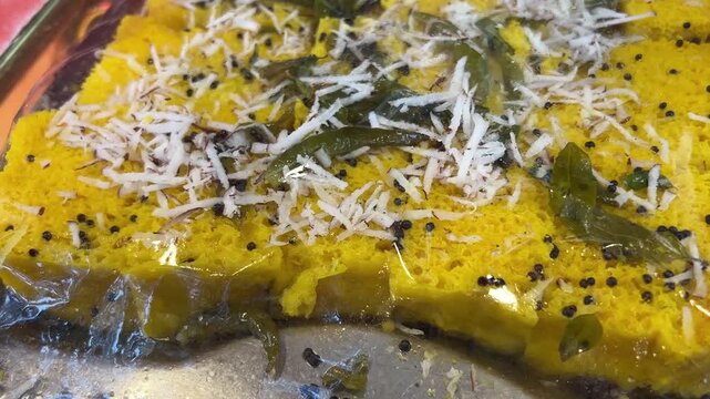 Dhokla garnished with coconut and coriander in a sweet shop in Kolkata, India. 