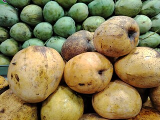Heap of fresh mangoes at the market stall delicious tropical fruit for healthy eating and vibrant...