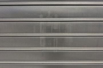 Perforated metal grille shutter for urban security