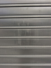 Perforated metal grille shutter for urban security