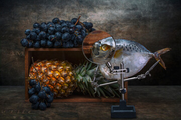 Still life with moonfish, grapes and pineapple