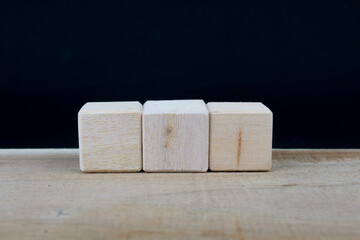 Three blank wooden blocks in a row with blank space for your text, letters or numbers.