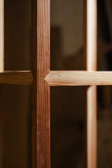 Detailed view of a wooden lattice structure with intricate joint work, showcasing craftsmanship and design.