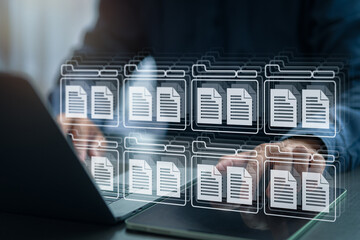 Businessman managing digital documents using virtual folder system on computer and tablet, representing cloud data storage, digital archive, and efficient document management in modern business.