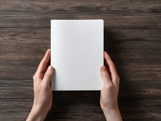 Blank White Notebook Held in Hands on Rustic Wooden Table