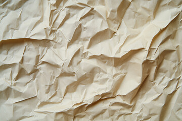 Crumpled beige kraft paper texture, close-up of wrinkled recycled paper surface for backgrounds and packaging designs
