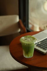 a cup of matcha on the wood table