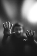 Scary picture of hands behind glass, horror ghost behind door, Halloween concept