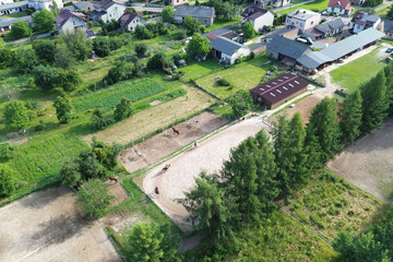 Rural horse riding school with training arenas and green fields