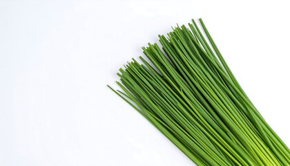 Obraz premium Freshly harvested organic chive bunch. A vibrant green culinary herb for healthy recipes, isolated on a white studio background.