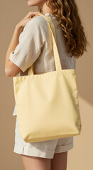 Woman holding a pale yellow tote bag