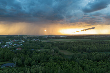 Rural area illuminated by last rays before storm arrives