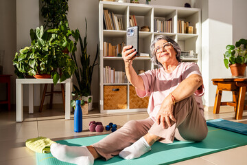 Old Lady Enjoys Post-Workout Selfie After Home Exercise Routine in Bright Living Room