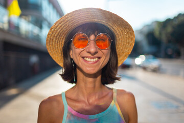 Close-up. Portrait of smiling beautiful young woman looking at camera in round fashionable...