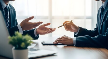Two businesspeople in suits discuss documents