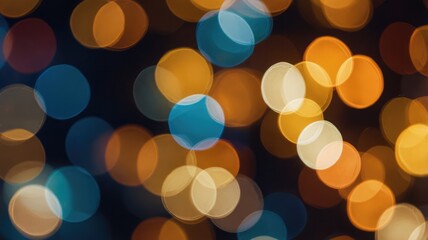 An abstract composition featuring blurred, out-of-focus lights in warm yellow, orange, and cool blue tones against a dark background.