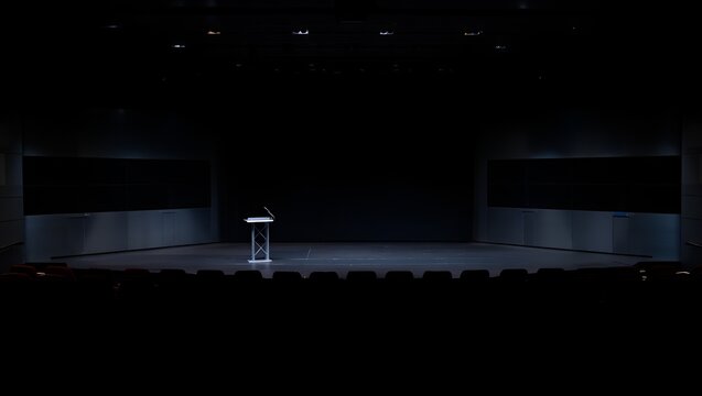 The empty stage awaits performance with a solitary lectern ready for the presenter's words