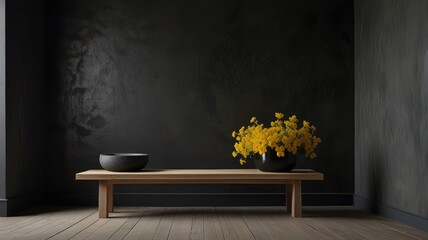 Still life featuring a wooden bench with a bowl and a vase of yellow flowers against a dark textured wall.