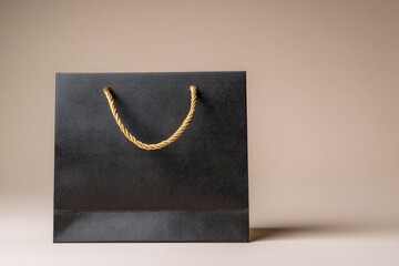 Black paper shopping bag with gold handles