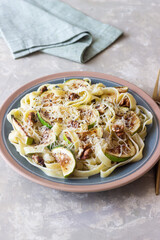 Fettuccine pasta with zucchini, nuts and parmesan cheese. Healthy eating. Vegetarian food. Italian cuisine.